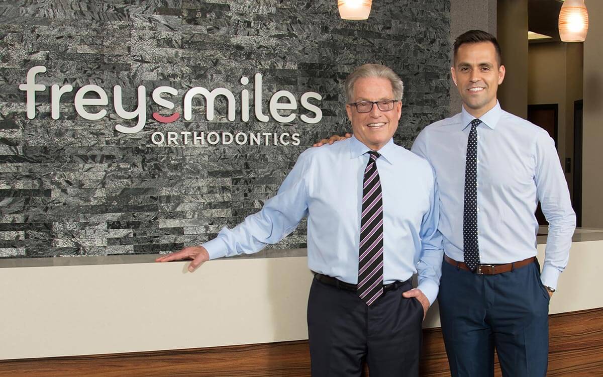 Orthodontists Dr. Gregg Frey and Dr. Daniel Frey at FreySmiles Orthodontics front desk