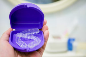 Clear plastic retainers in a purple case